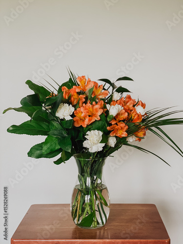 Wallpaper Mural Elegant Floral Bouquet in Glass Vase on Wooden Table, Orange Alstroemeria and White Carnations, Minimalist Home Decor, Fresh Flower Arrangement, Modern Still Life Photography, Isolated Background Torontodigital.ca