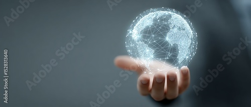 A futuristic concept of a human hand holding a holographic globe. The digital world is represented through glowing connections, symbolizing global communication and technology.
