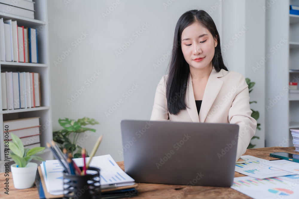Asian Woman Working at Desk with Laptop Asian Woman Working at Desk with Laptop