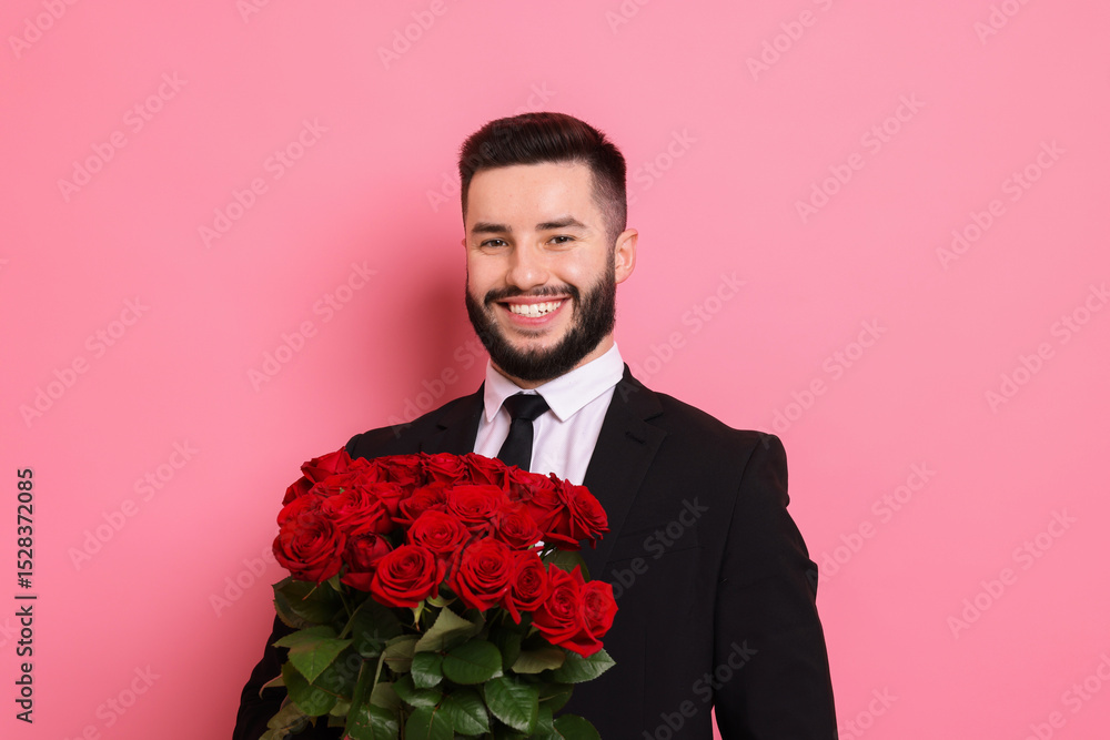 Happy man with bouquet of red roses on pink background Happy man with bouquet of red roses on pink background
