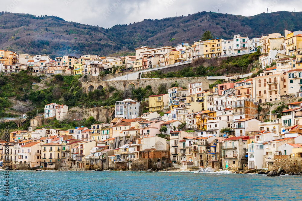 Naklejka premium Italy, Calabria, Scilla. Houses built on the cliff side above the sea.