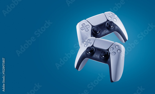 2 video game controllers floating in the air on a blue background - copy space