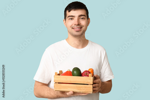 Young man with box of food ...