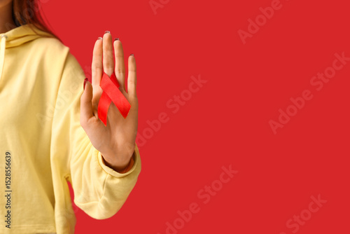 Woman with red ribbon on co...