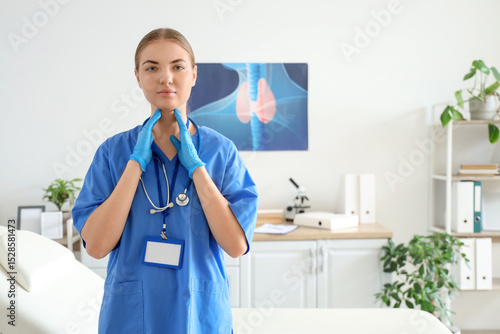 Female endocrinologist self-examining thyroid gland in clinic