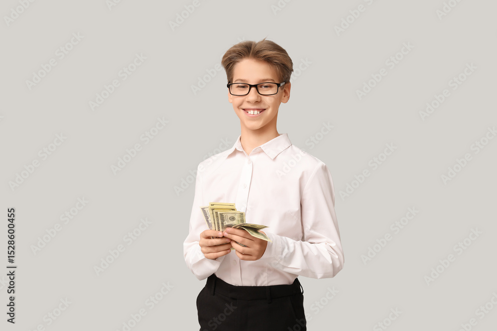 Teenage businessman with money on light background Teenage businessman with money on light background