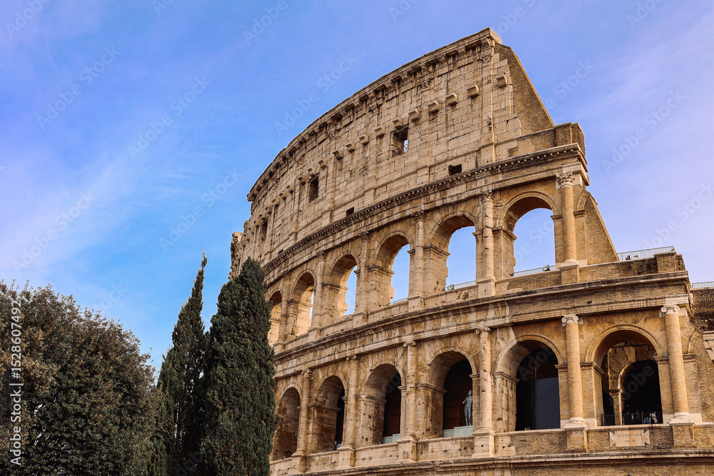 Obraz premium Panoramic view of old Colosseum in Rome. Beautiful popular of ancient landmark. Famous card of city of Rome, Italy. High quality photo