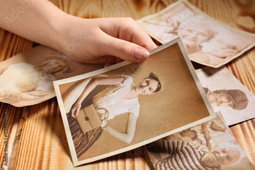 Female hand with old photos...