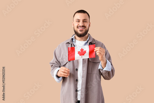 Smiling young man holding a...