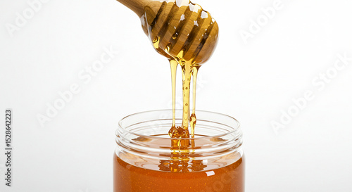 Golden Honey Drizzling from Spoon into Jar – Minimalist White Background Wide Shot