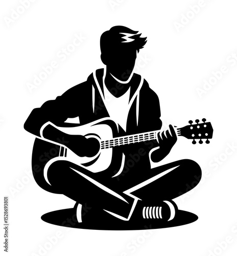 Silhouette of a young man playing acoustic guitar