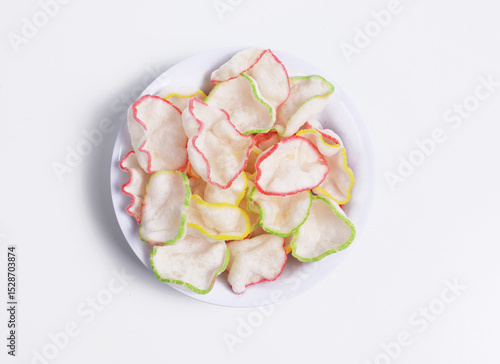 Deep-fried kerupuk bawang or Garlic crackers in a white bowl, an Indonesian cracker made from tapioca flour and flavored with garlic or prawn and come in various edge colors. 