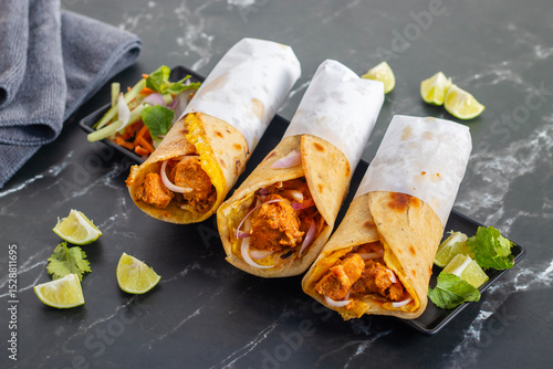 Egg chicken roll is a popular street food made with a flaky paratha, spiced chicken, egg layer, onions, and sauces, wrapped and served hot.
