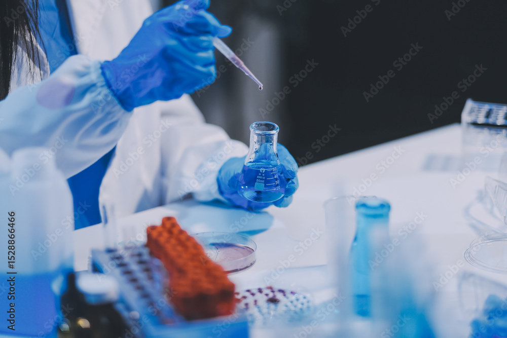 Fototapeta premium Research, experiment and medical trial being done by a scientist in a lab, science facility or hospital. One young, serious and professional researcher organizing, sorting or making a discovery
