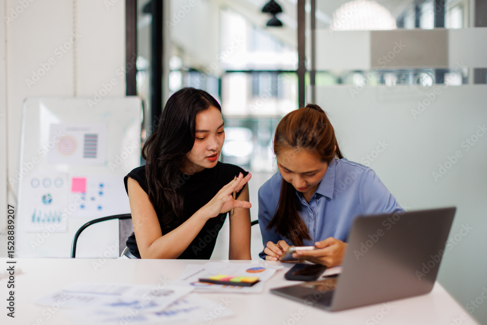 Two asian business woman Accounting using calculating income-expenditure and analyzing real estate investment data report Financial and tax systems concept. Two asian business woman Accounting using calculating income-expenditure and analyzing real estate investment data report Financial and tax systems concept.