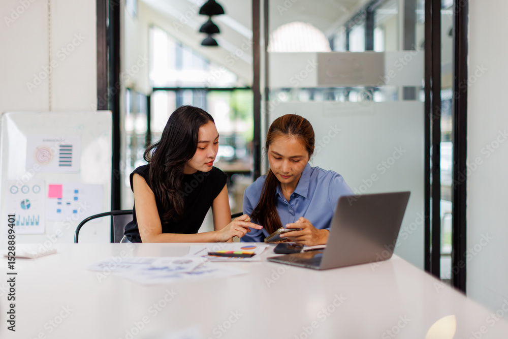 Two asian business woman Accounting using calculating income-expenditure and analyzing real estate investment data report Financial and tax systems concept. Two asian business woman Accounting using calculating income-expenditure and analyzing real estate investment data report Financial and tax systems concept.