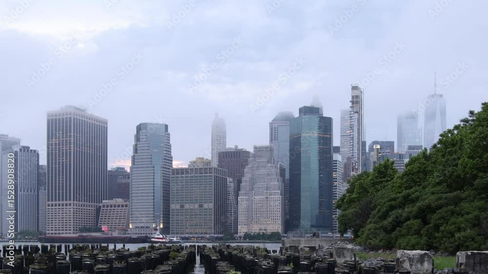 new york city skyline sunset view time lapse (timelapse of clouds moving east river promenade vista from brooklyn heights bridge park) boats floating time passing nyc manhattan skyscraper buildings new york city skyline sunset view time lapse (timelapse of clouds moving east river promenade vista from brooklyn heights bridge park) boats floating time passing nyc manhattan skyscraper buildings