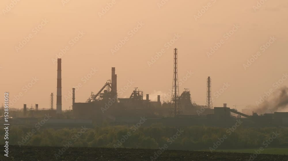 The Industrial Complex at Dusk featuring Smokestacks, Silhouettes, and Scenic Views The Industrial Complex at Dusk featuring Smokestacks, Silhouettes, and Scenic Views