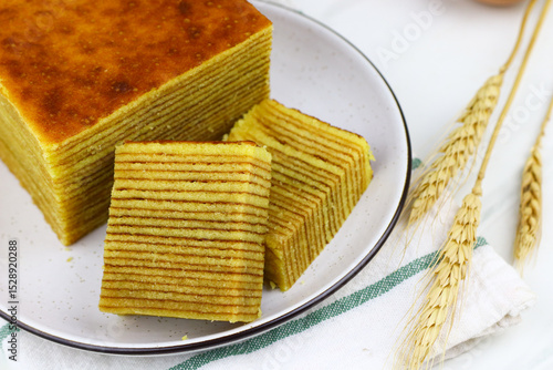 Lapis Legit or Spekkoek, One of Indonesian traditional layered cake. Lapis legit especially served during celebration or special day. White marble background.