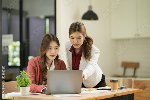 Asian business woman working and talking at the office