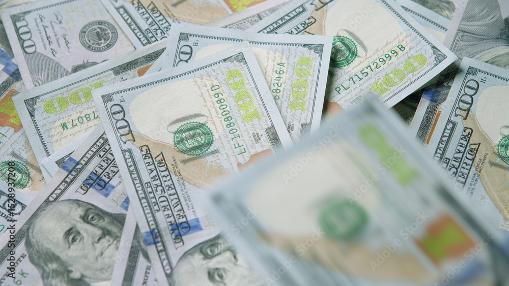 Fototapeta premium A large pile of U.S. Hundred Dollar Bills, representing cash and the concept of wealth in finance