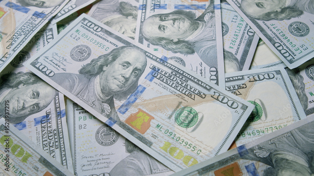 Stacks of Hundred Dollar Bills Are Placed Out and Spread Across the Surface for Display Stacks of Hundred Dollar Bills Are Placed Out and Spread Across the Surface for Display