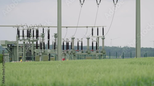 Umspannwerk mit Windrädern und Stromleitungen in ländlicher Landschaft – Energieinfrastruktur in Deutschland