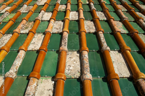 Old colorful mediterranean tile roof on cathedral closeup