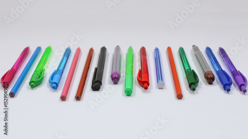 Colorful Pens, Pencils, and Markers in a Row. Side View with Selective Focus