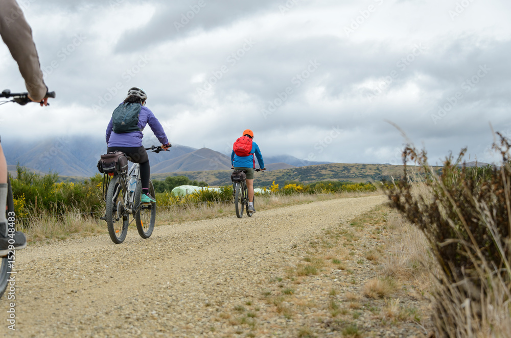 Fototapeta premium Couple cycling Otago Central Rail Trail. South Island. New Zealand.
