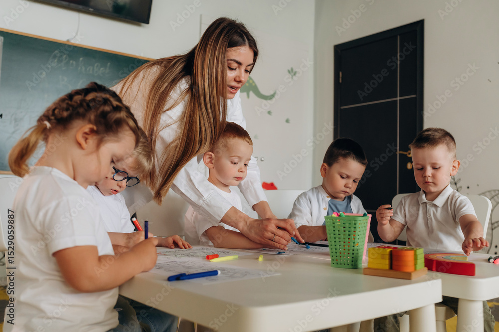 Obraz premium Helping the kids, education. Children in kindergarten with their teacher