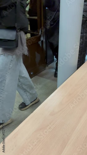 Workers leave the factory through the turnstile. Unrecognizable people pass the electronic turnstile. Vertical format