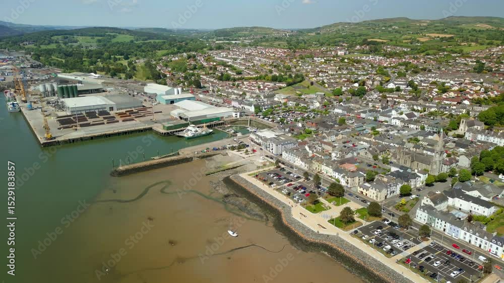Overhead reversing aerial video of Warrenpoint, County Down, Northern Ireland, UK on a bright and sunny day. Filmed in 4K, 60FPS and with Rec709 color. Overhead reversing aerial video of Warrenpoint, County Down, Northern Ireland, UK on a bright and sunny day. Filmed in 4K, 60FPS and with Rec709 color.