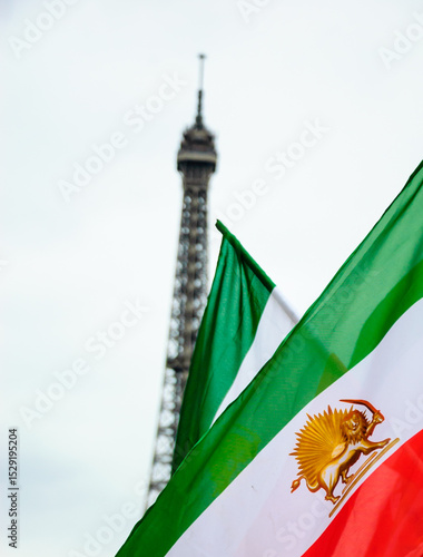 Old Iranian flag (Iran's flag under the former Shah regime) and Eiffel tower at background. Paris, France. 