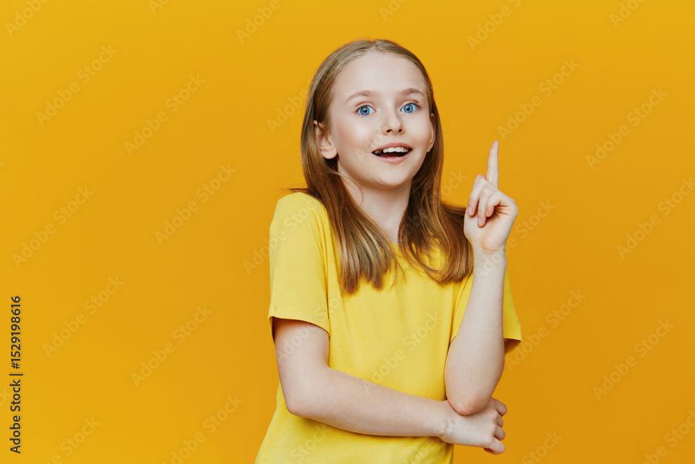 Cheerful young girl with light hair in a yellow shirt on a bright yellow background, expressing excitement and creativity through her joyful gesture Cheerful young girl with light hair in a yellow shirt on a bright yellow background, expressing excitement and creativity through her joyful gesture