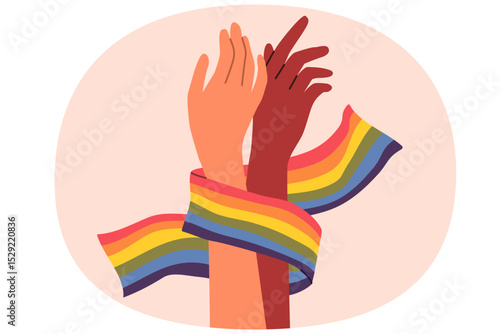 Hands of non-binary couple holding LGBT flag symbolizing love and unity between transgender and gay or lesbian. Pride month concept to promote the idea of tolerance towards LGBT people.