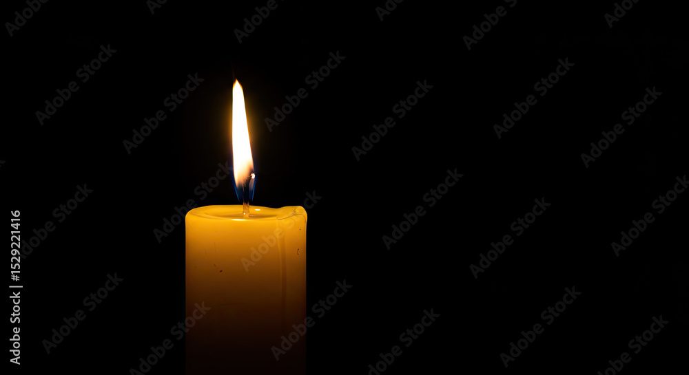 Single Lit Yellow Candle on black Background Single Lit Yellow Candle on black Background