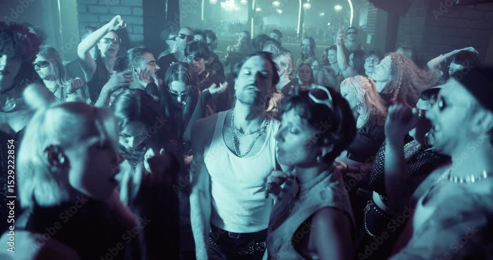 Diverse Party Crowd Enjoying Time in an Underground Nightclub, Dancing Energetically Under Dynamic Lights and Pulsating Music. Young Men and Women Having an Emotional Night Out