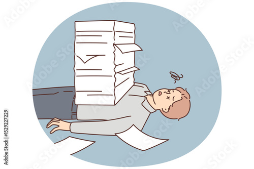 Stressed man lying under paperwork pile