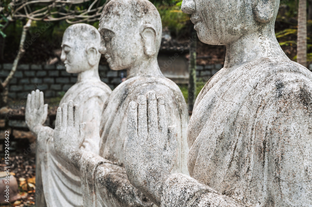 Fototapeta premium Close-up of the folded arms of the Buddha statue. The concept of Buddhism