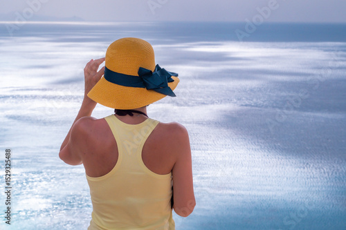 Young woman relaxing on the beach near the sea during a summer season