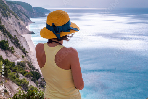 Young woman relaxing on the beach near the sea during a summer season