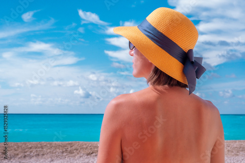 Young woman with hat on the beach
