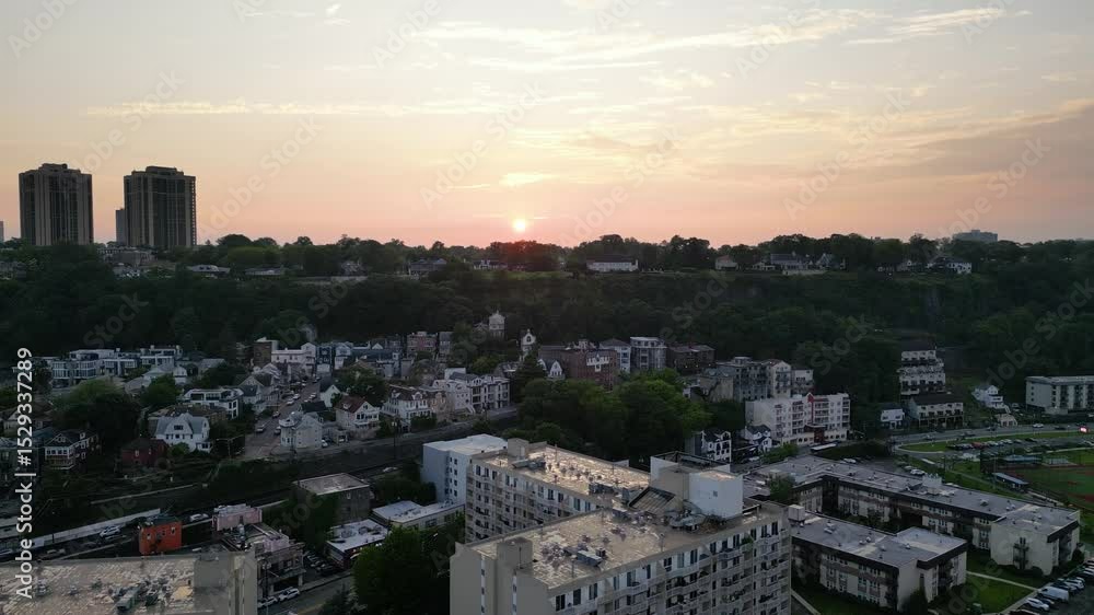 Drone sunset aerial over Fort Lee NJ showing the Hudson River and New York City skyline in warm evening light with clear skies and scenic city backdrop Drone sunset aerial over Fort Lee NJ showing the Hudson River and New York City skyline in warm evening light with clear skies and scenic city backdrop