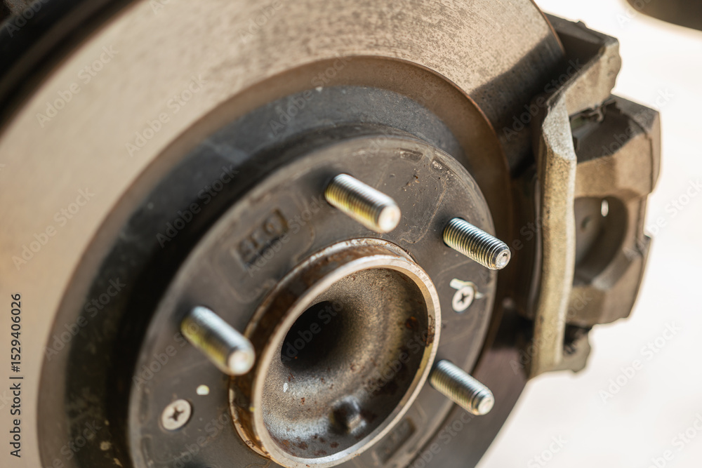 Car wheel disc brake and caliper part that disassembled from inspection. Vehicle equipment part object, close-up with selective focus. Car wheel disc brake and caliper part that disassembled from inspection. Vehicle equipment part object, close-up with selective focus.