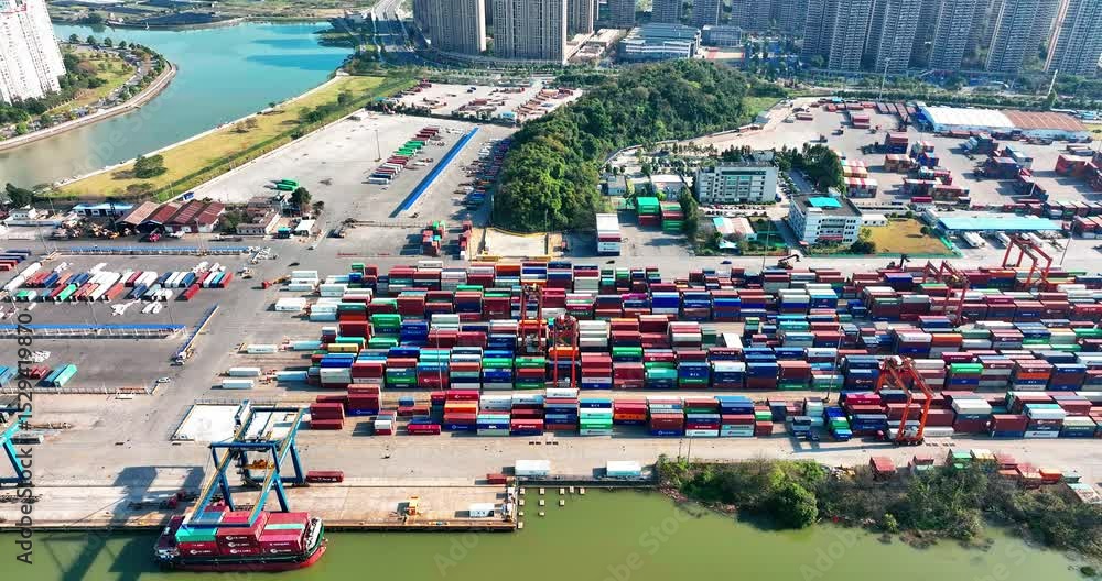 Guangzhou dongsha container terminal port aerial overview shows stacks of shipping containers and active operations