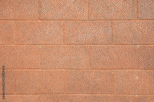 Decorative brown embossed street tiles with oval elements closeup