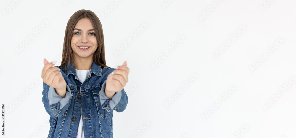 Obraz premium Young caucasian woman showing mini heart sign isolated on white background, Spreading love and happiness concept