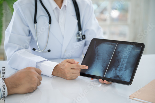 doctor or adiologic technologist diagnose x-ray image of spine lumber vertebrae that shows herniated disc disease of patient.