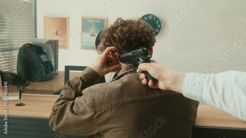 Dolly away shot of male client filling in form at tellers counter when two armed unprofessional robbers pointing gun at man threatening surprised customer and staff while breaking into bank office